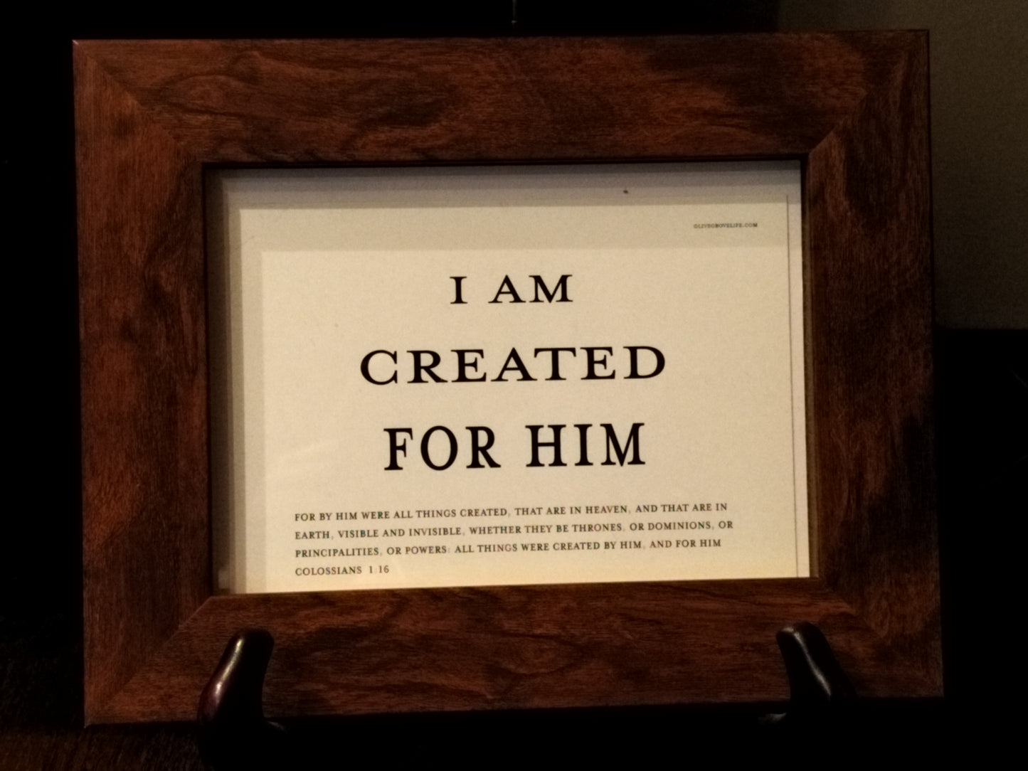 Framed text print with 'I AM CREATED FOR HIM' quote in a wooden frame.