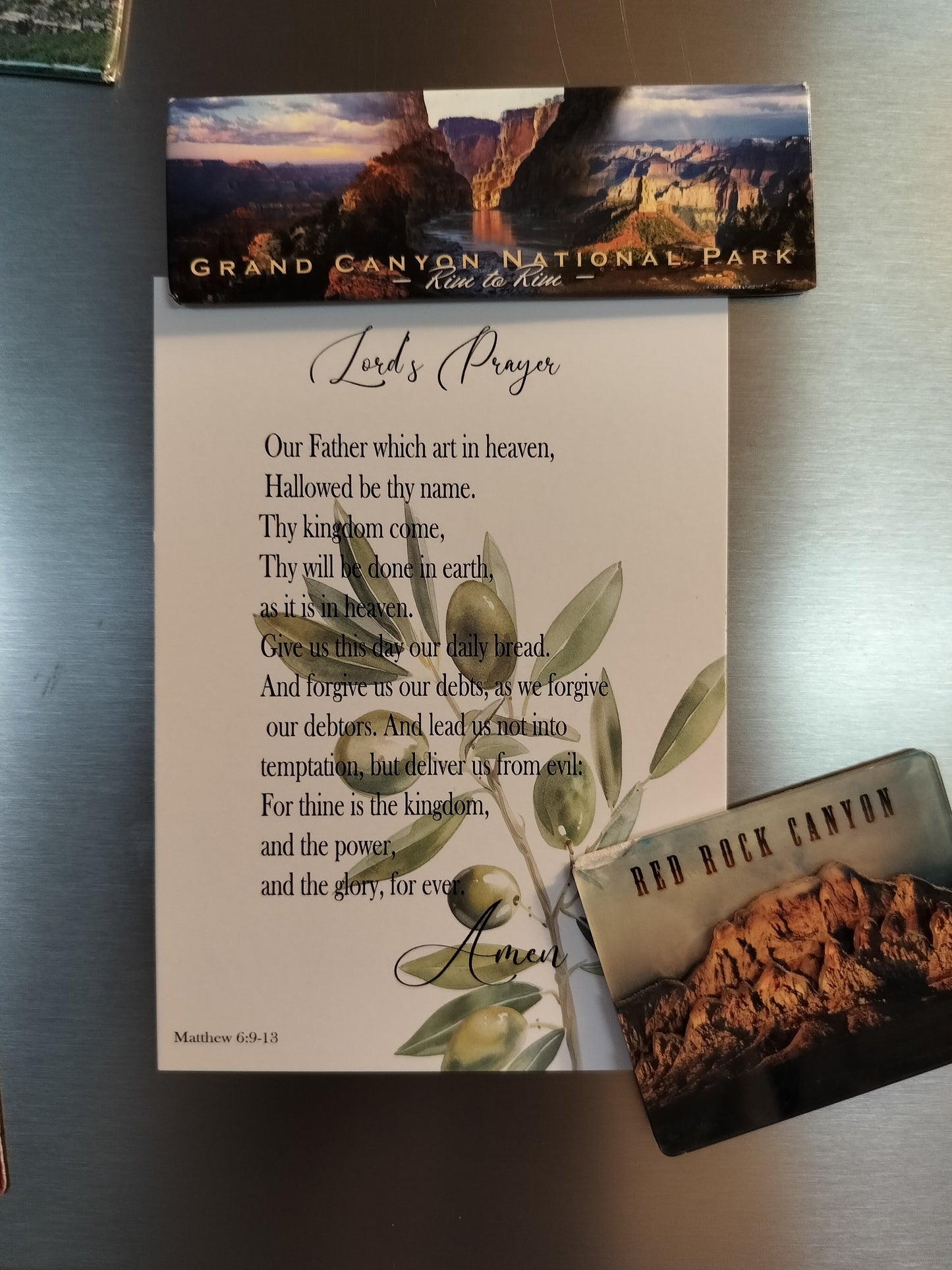 card with the Lord's Prayer on a metallic surface