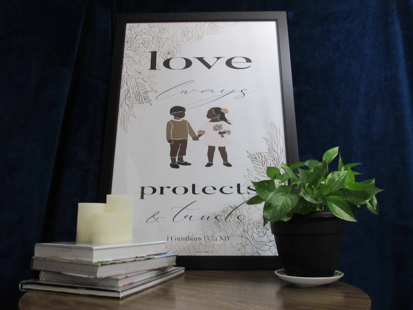 1 Corinthians 13:7a NIV Art Print on table with plant, books, & candles